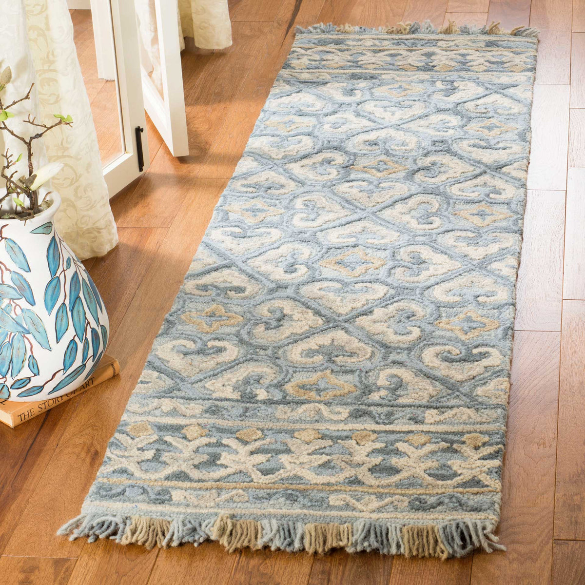 Softly textured blue and beige runner with classic motifs and blue-and-cream fringe
