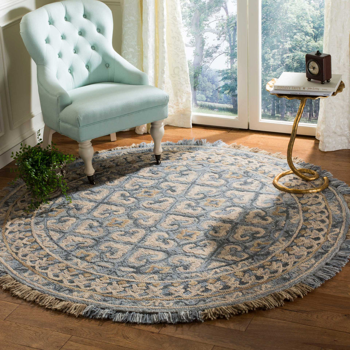 An ornate light beige and blue rug with fringed edges creates a welcoming reading nook