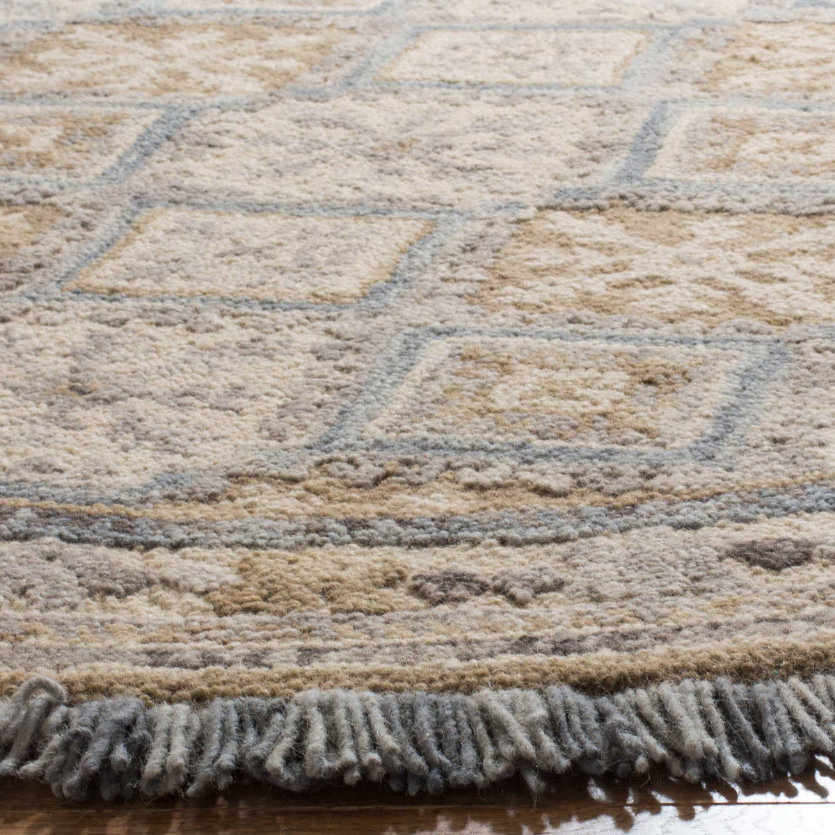 Plush hand-tufted pile highlights pale blue diamonds, delicate florals, and soft blue fringe