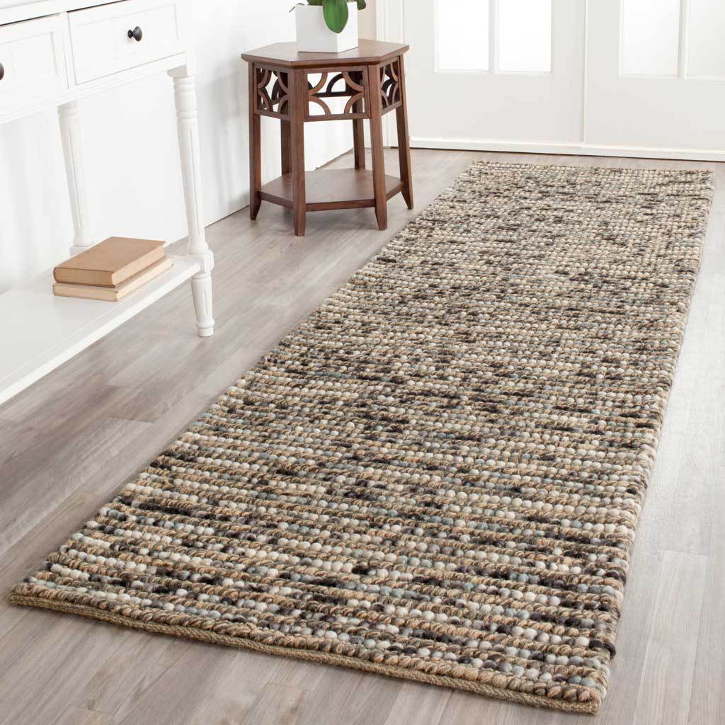 A blue-and-neutral runner adds earthy color and thick woven texture to the floor