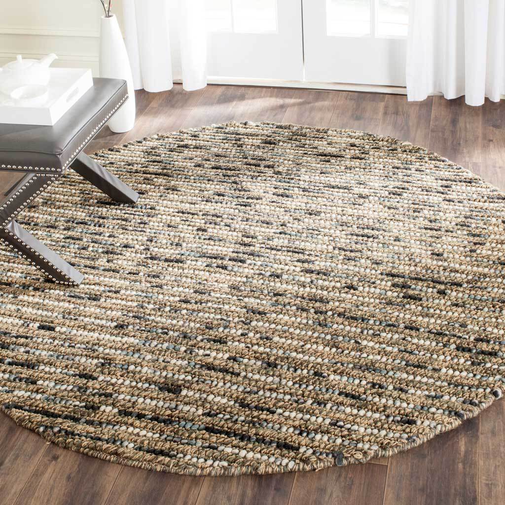 Blue and tan woven rows give this round rug a warm, textured look beneath furniture