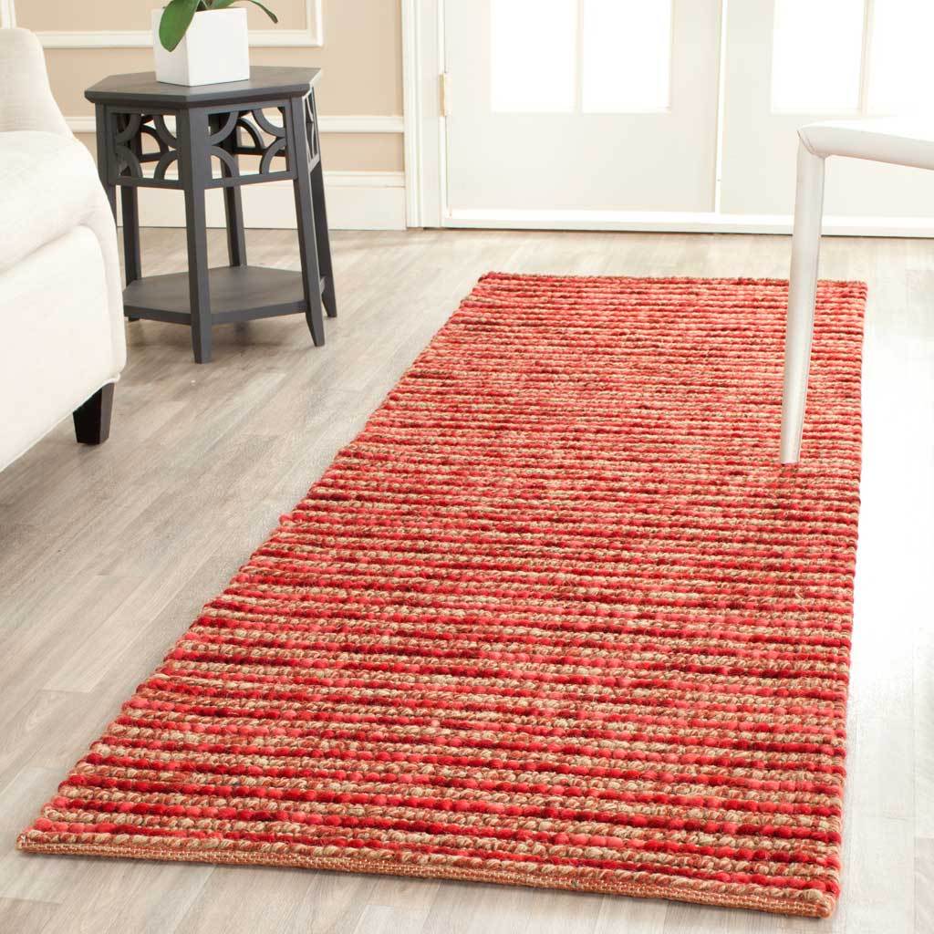 A red runner brightens the floor with textured stripes and warm, varied shades