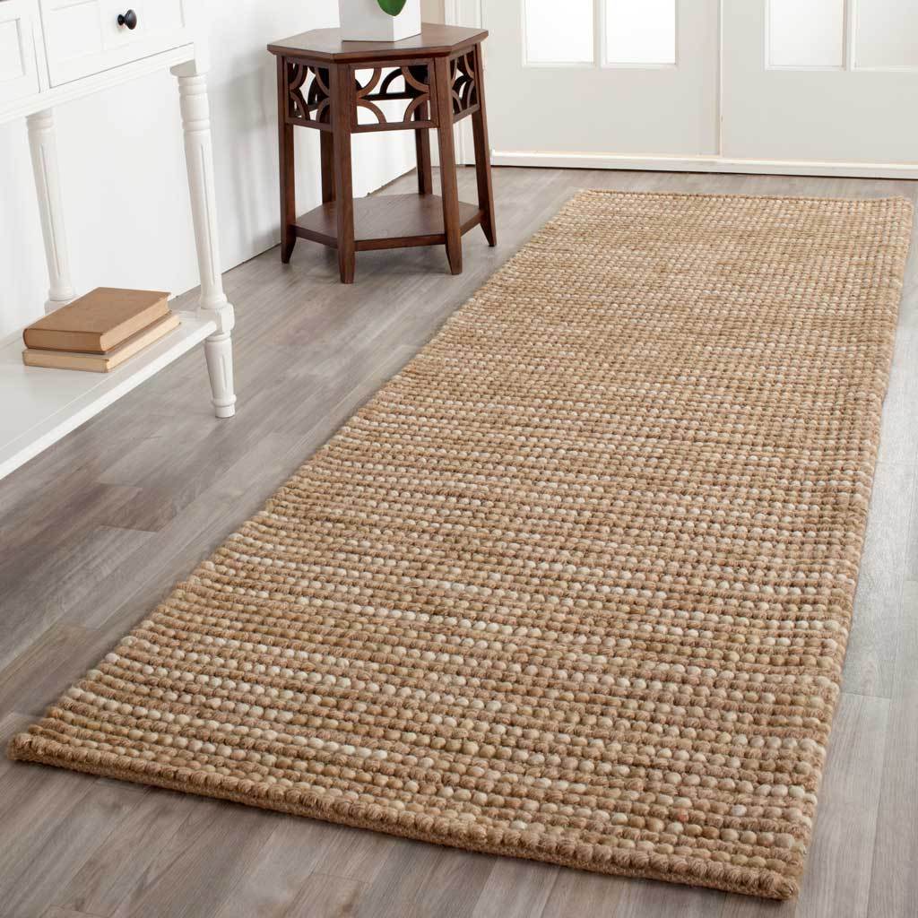 A beige runner warms the floor with subtle tonal variation and inviting woven ridges
