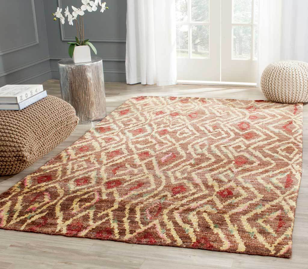 A brown and gold geometric rug with red accents brings warmth to a bright living room