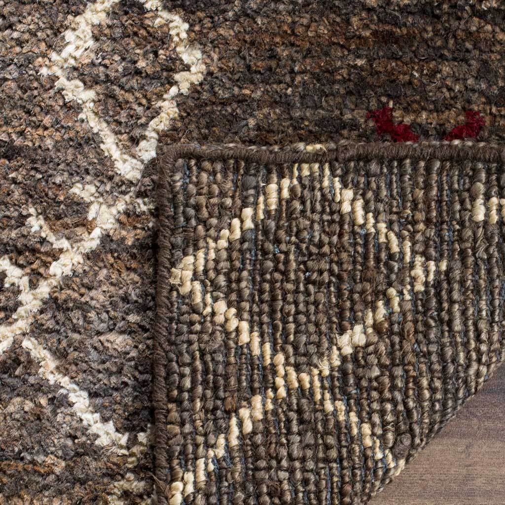 Tightly woven, cream-flecked backing complements the rug's hand-knotted geometric surface