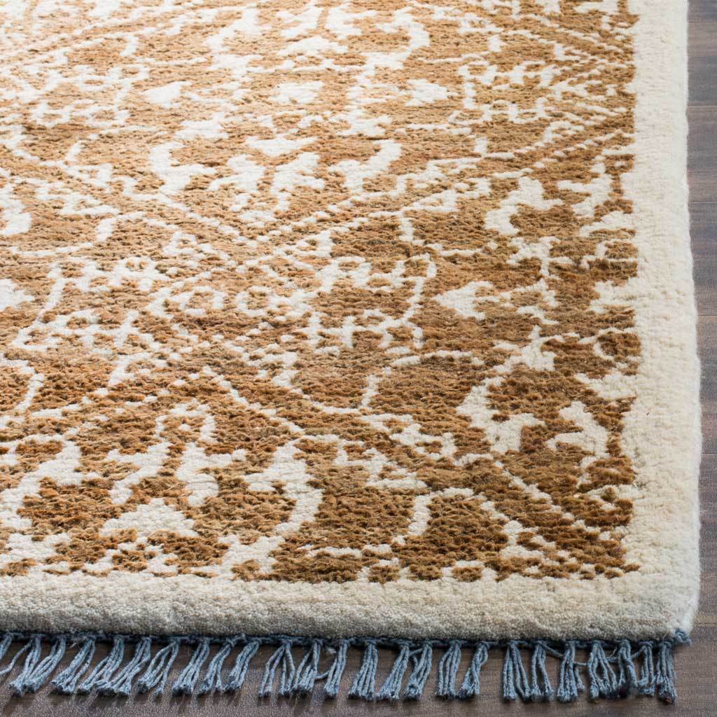 The rug's textured brown and beige pattern ends in a pale border and blue-gray fringe