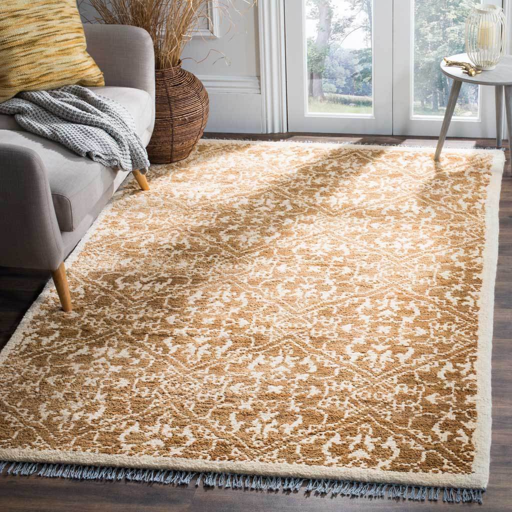 An ornate brown and beige rug brings warmth and pattern beneath a sofa
