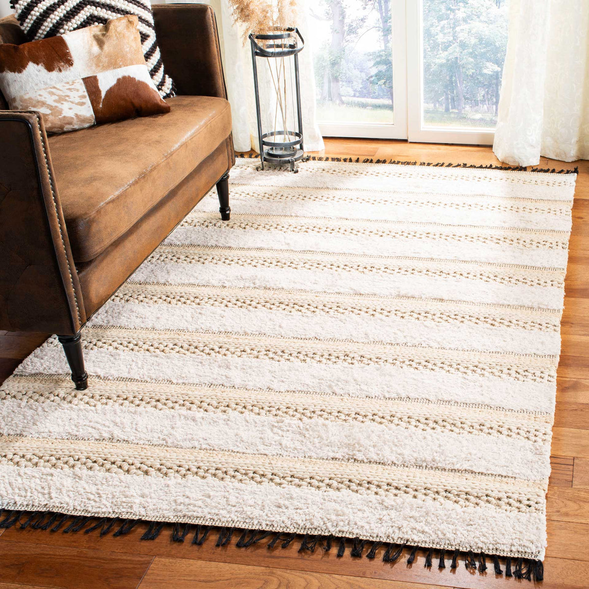 Textured ivory and beige stripes soften the living room floor, framed by black fringe