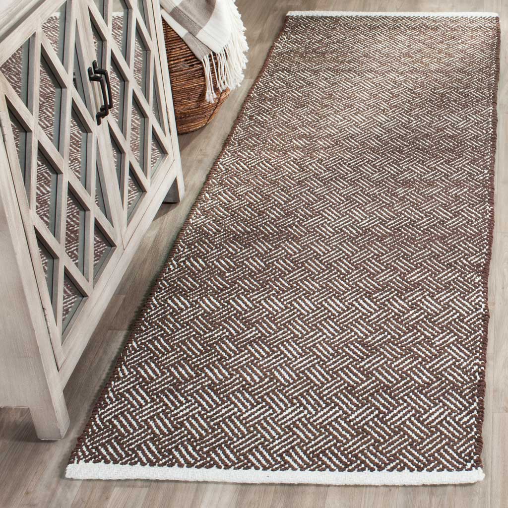 Earthy brown chevrons bring crisp geometric texture to this slender, flat-woven runner.