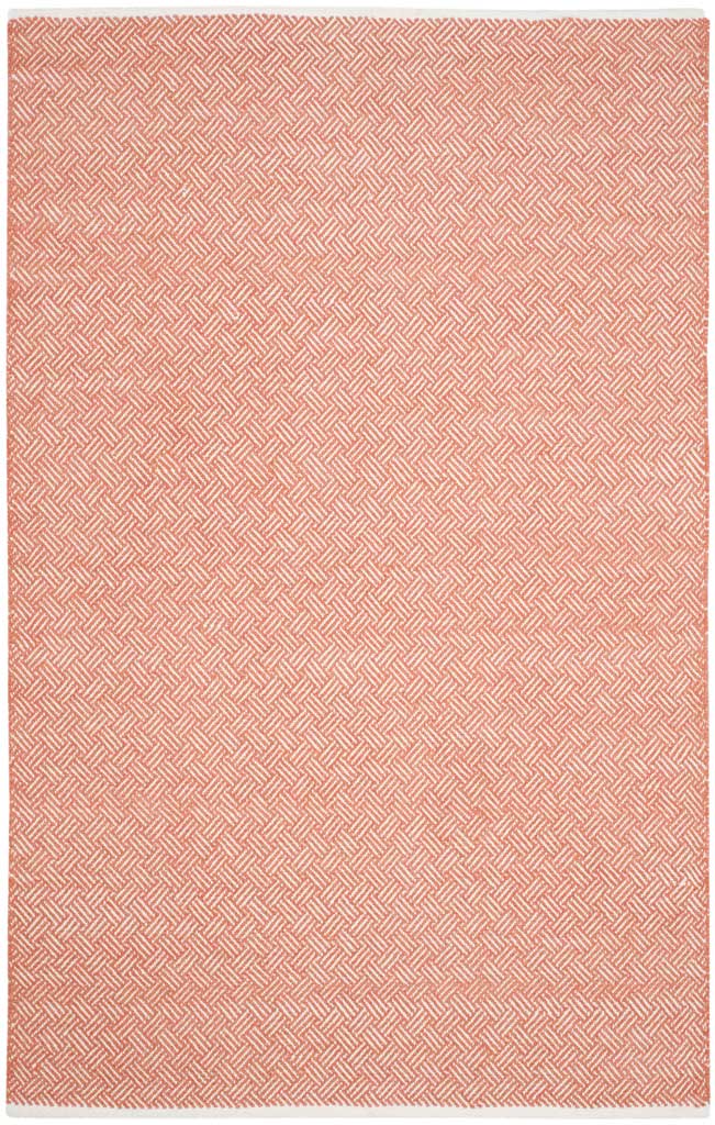 A 5' x 8' cotton rug weaves vibrant orange and ivory into a fine geometric pattern.