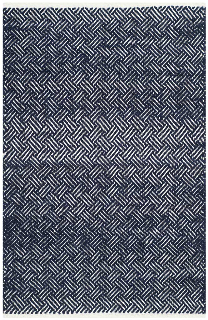 A small navy and ivory cotton rug adds graphic herringbone pattern in an accent size.