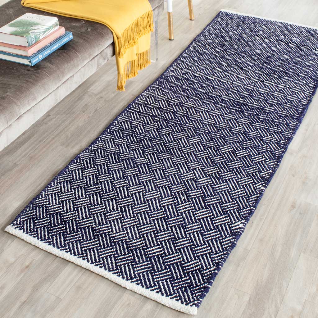Navy chevrons and crisp ivory end borders add graphic texture to this flat-woven runner.