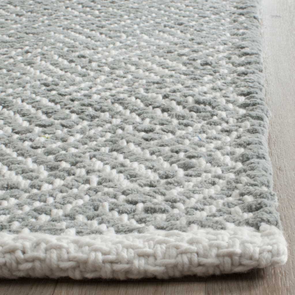 Chunky gray and ivory cotton weave meets a thick, neatly finished edge.