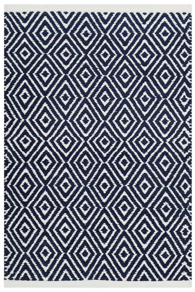 A compact navy accent rug brings graphic ivory diamonds to smaller spaces.