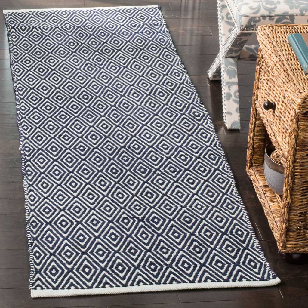 Bold navy and white diamond motifs bring striking contrast to this cotton runner