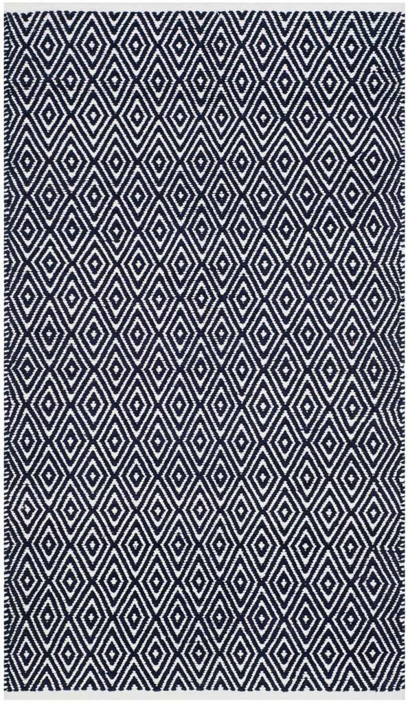 Intricate ivory diamonds repeat across this rectangular navy rug.