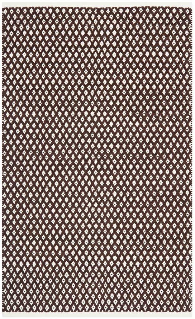 A small brown cotton rug adds warmth with an allover grid of ivory diamond motifs.