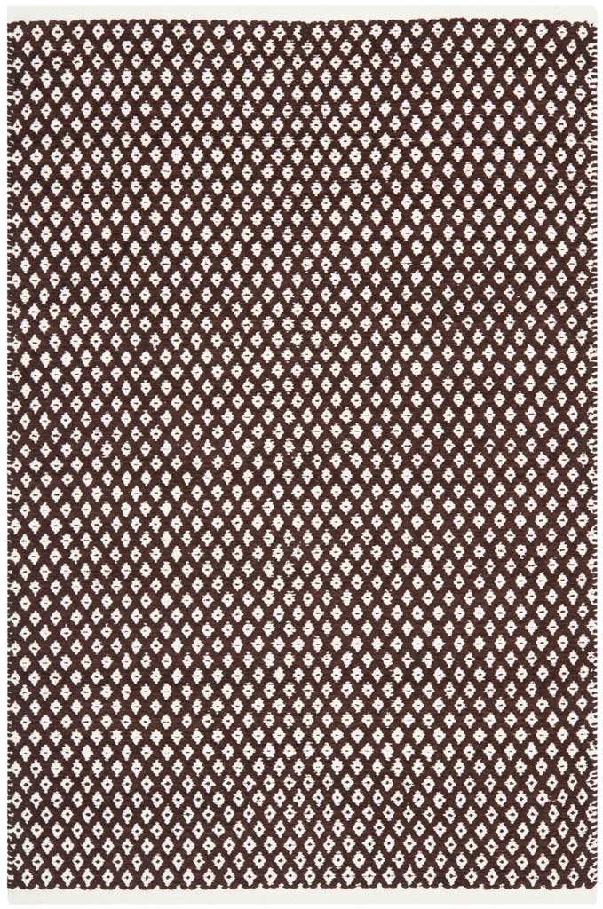 A 4 x 6 ft brown rug features dense ivory diamonds and neatly finished edges.