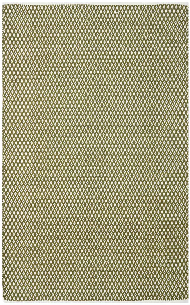 Olive green and ivory geometric motifs run edge to edge across this soft cotton rug.