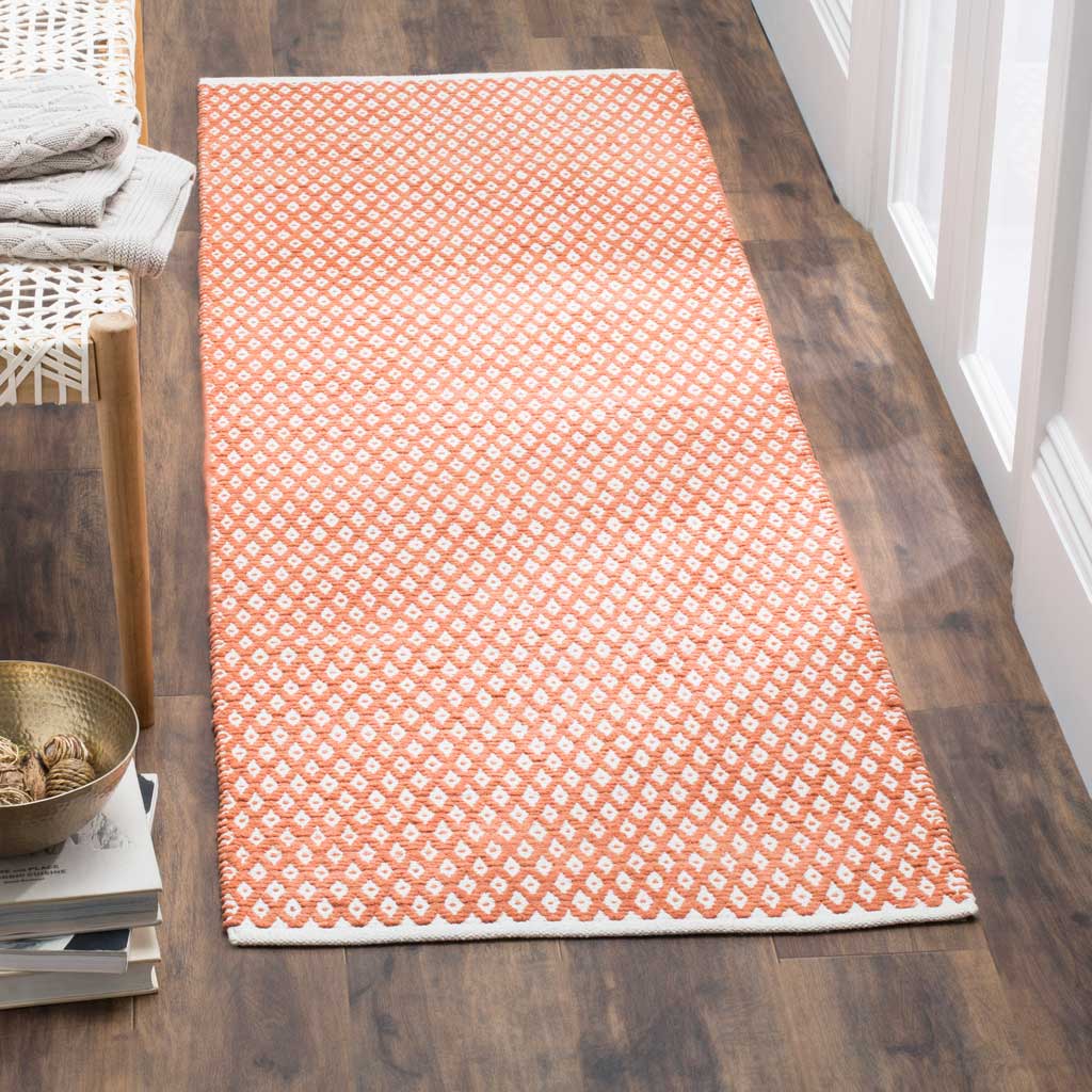 Warm orange and white diamond motifs add lively geometric texture to this runner