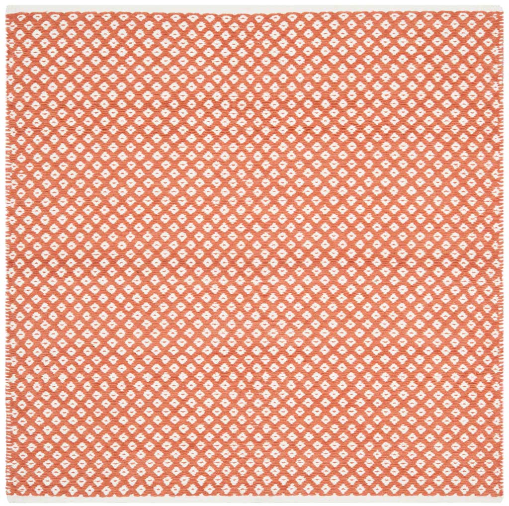 A square orange rug adds vibrant color and a crisp ivory diamond lattice to the floor.