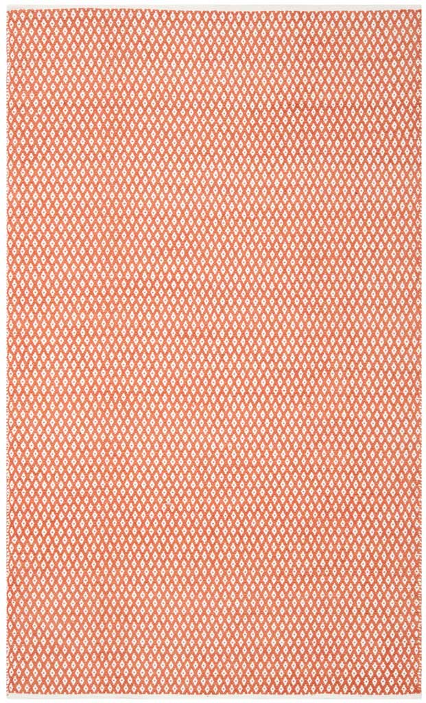 A 5 x 8 ft orange rug layers repeating ivory diamonds over a low-profile cotton weave.