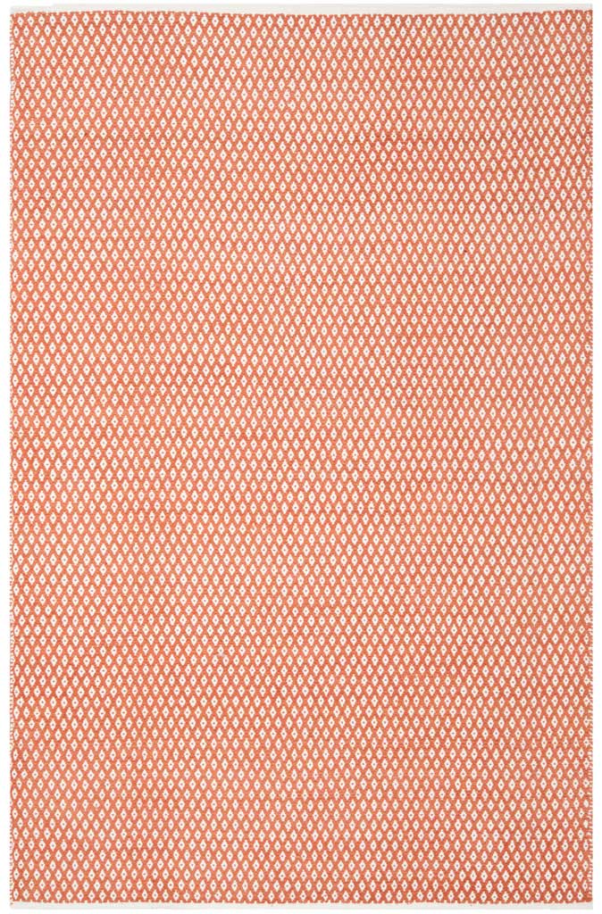 Orange and ivory diamond motifs bring cheerful color to this 6 x 9 ft flat-woven rug.