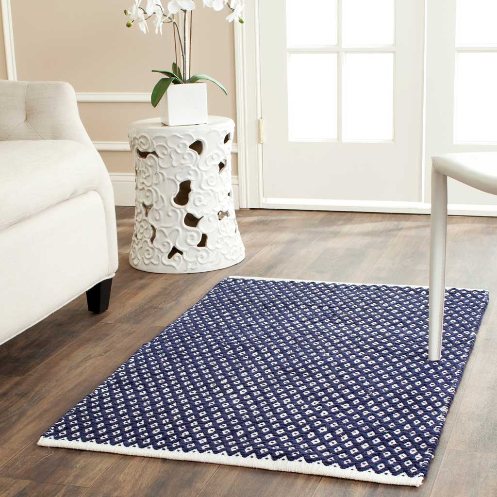 A small navy diamond-pattern rug brings graphic color and texture to a cozy corner.