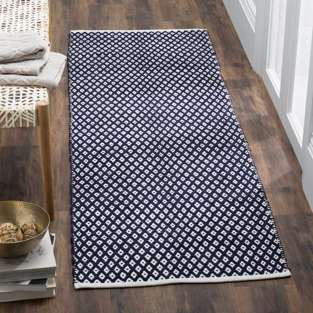 Navy and white geometric diamonds give this cotton runner a bold patterned look