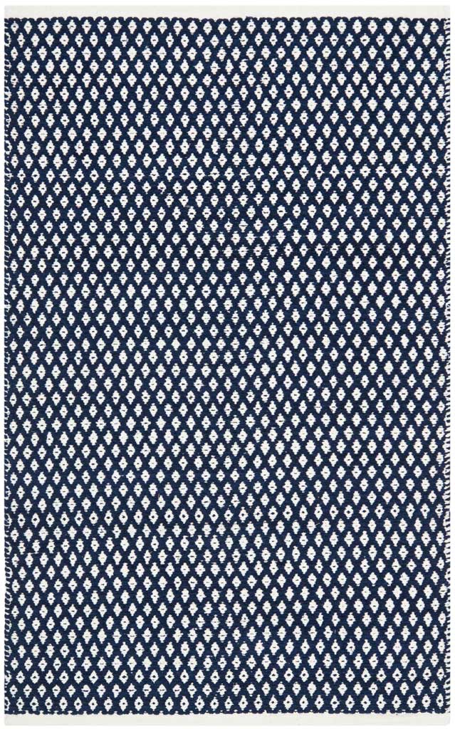 A 3 x 5 ft navy rug adds contrast with white latticework and a low-profile weave.