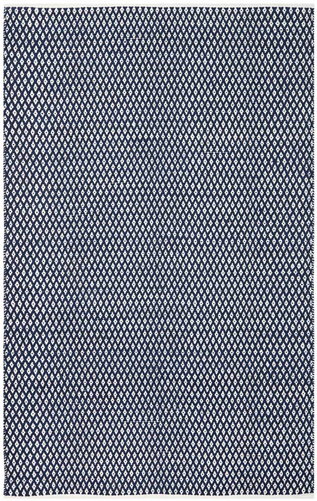 Navy and white geometric diamonds repeat across this generously sized flat-woven rug.