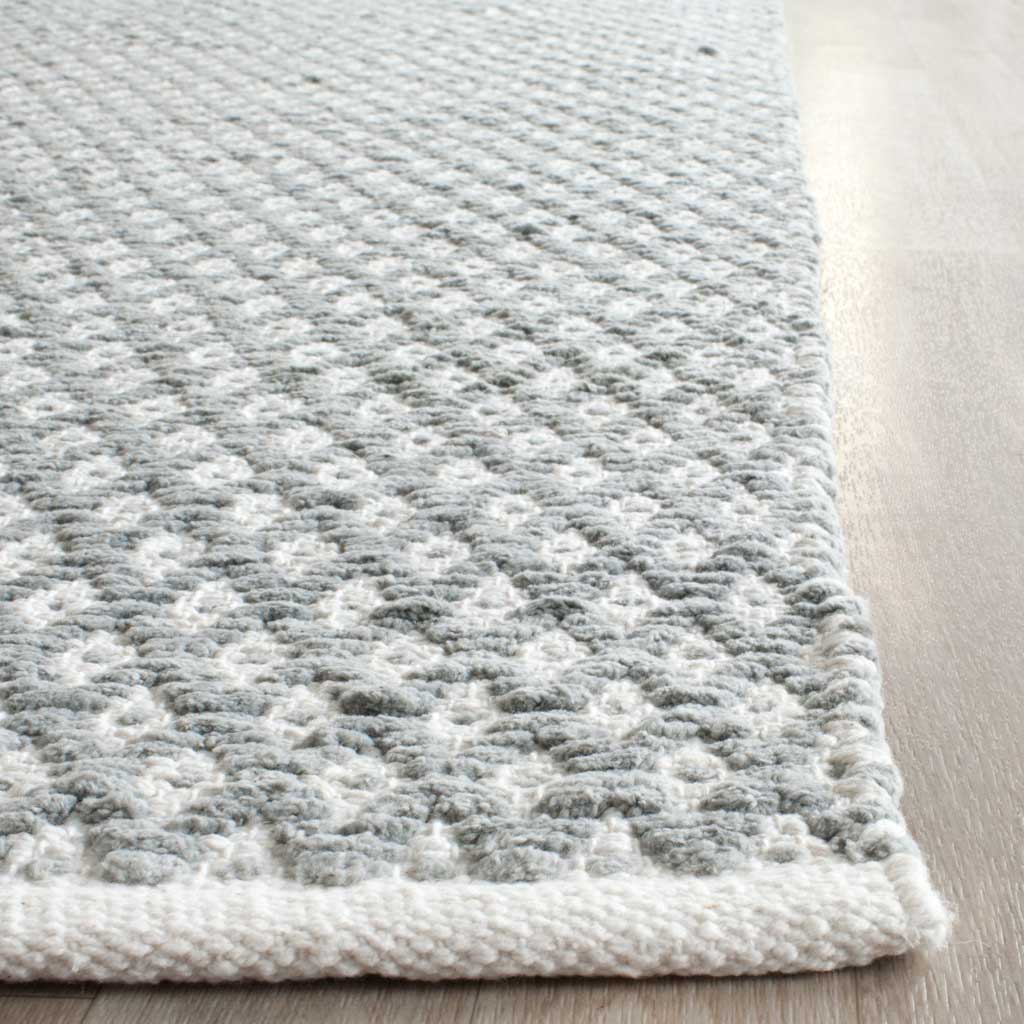 Textured gray and white diamonds meet a thick white woven edge