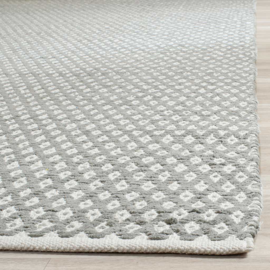 Low-profile gray and ivory diamond weaving meets a neatly finished light edge.