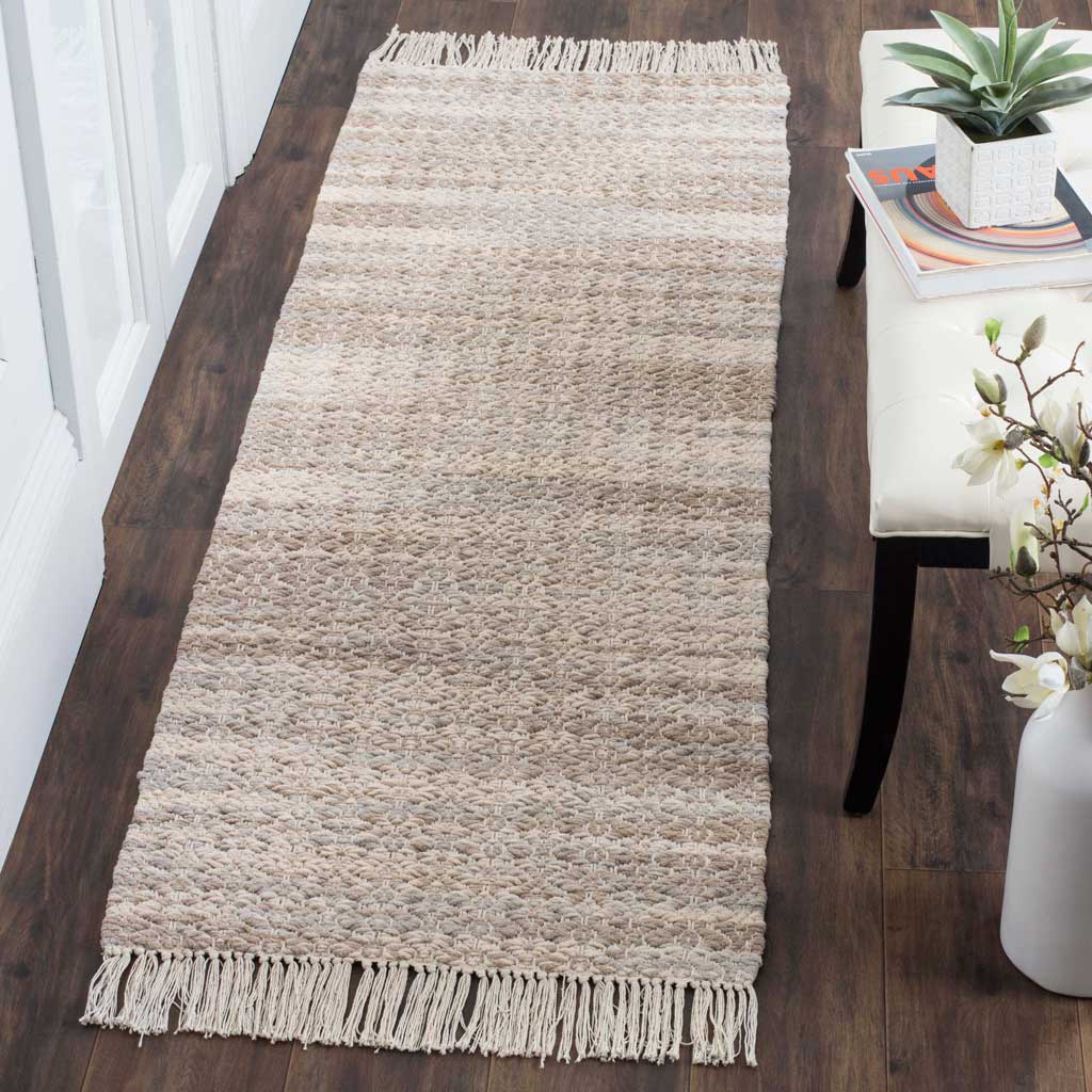 Textured beige and ivory runner with fringe adds warmth to a dark wood floor