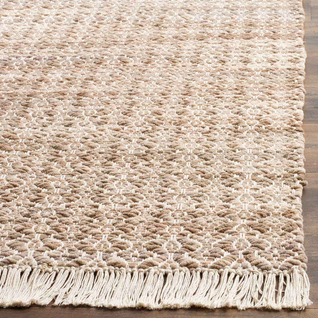 Ivory fringe trims the textured cotton weave and its delicate geometric pattern