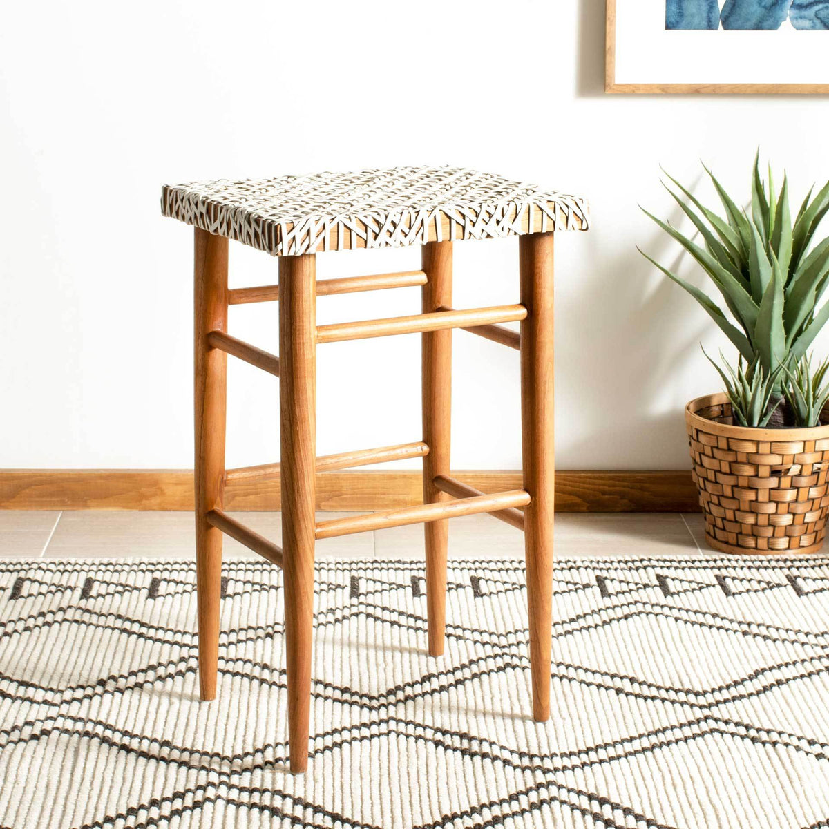 A woven white leather seat and slender natural wood legs give this barstool breezy coastal appeal