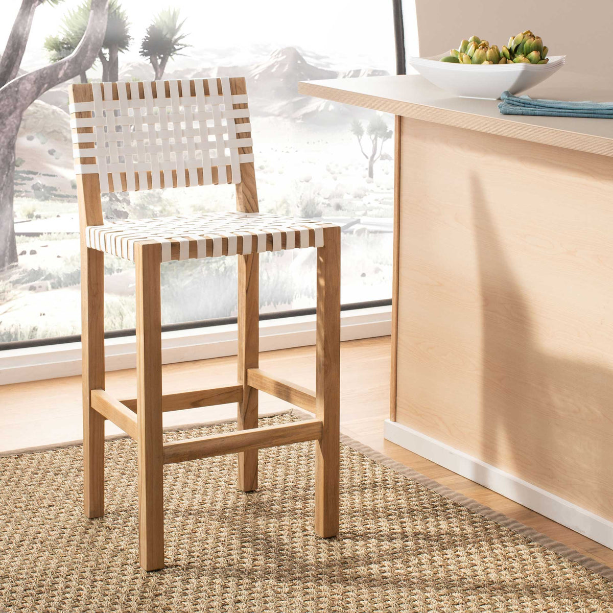 Natural teak and a white leather weave create a breezy counter stool with a supportive footrest