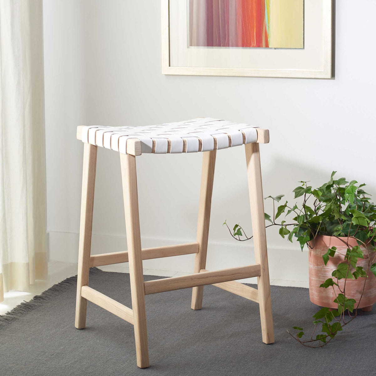 White leather weaving and light wood bring an airy accent to a relaxed living area