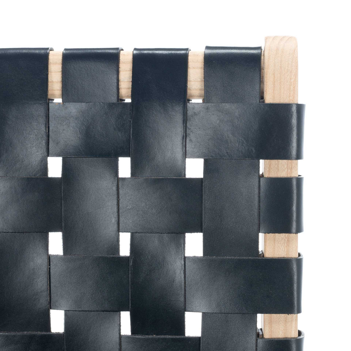 Wide black leather straps create a bold basket weave against natural wood grain.