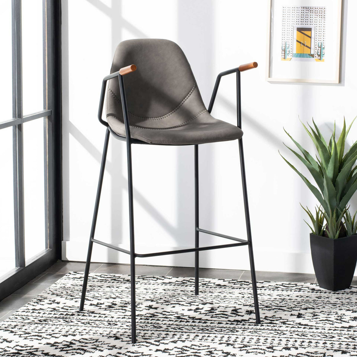 Ash-gray faux leather barstool blends a stitched, curved seat with tall black legs and wood-tipped arms