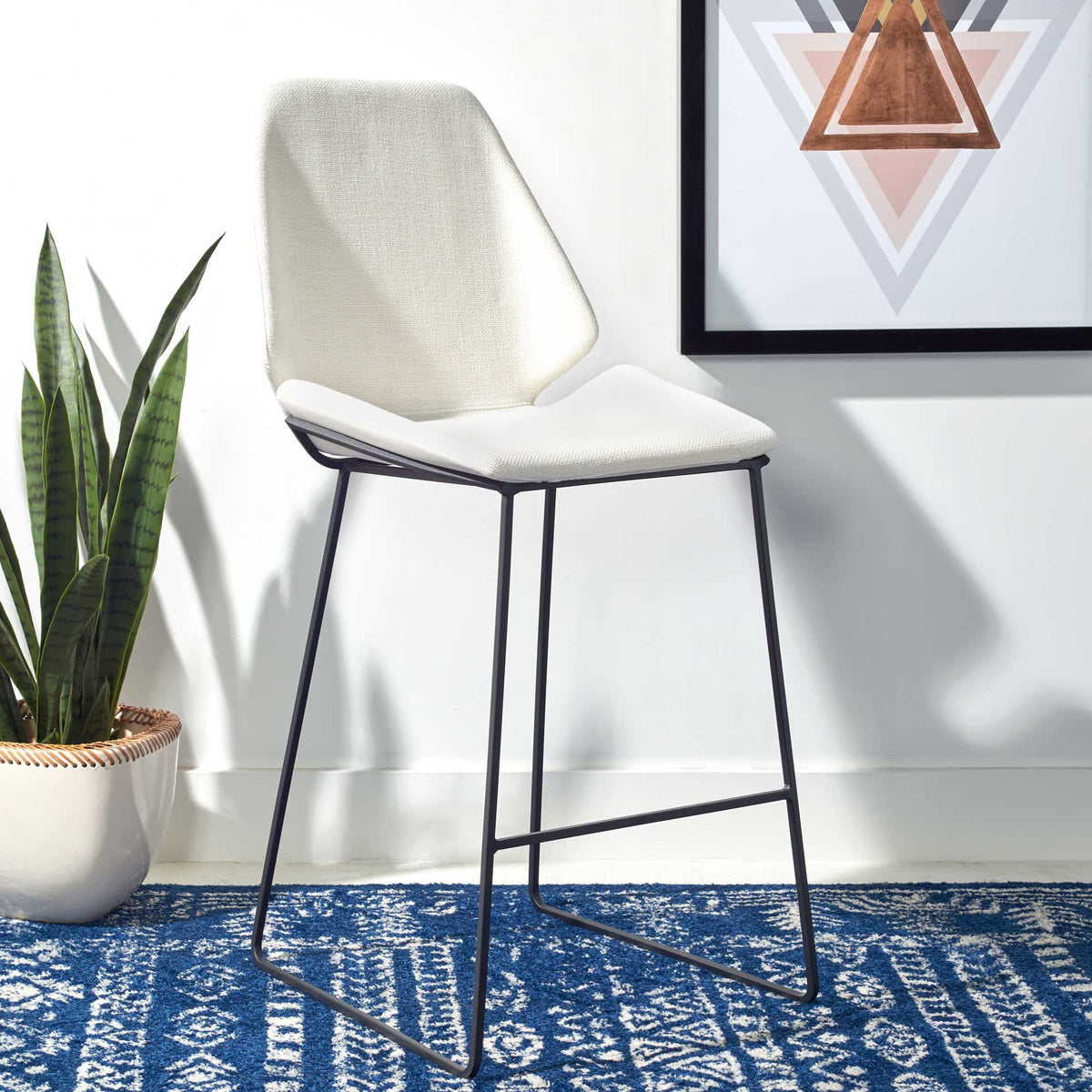 A bright white shaped seat and graphic black footrest create fresh, modern contrast.