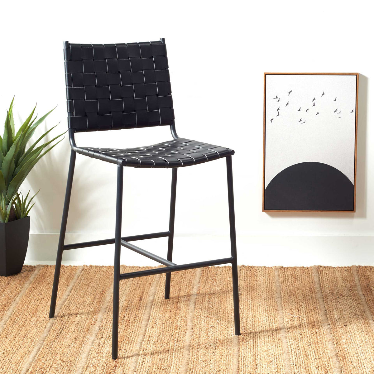 Black woven leather and an open metal base bring contemporary style to warm, natural surroundings.