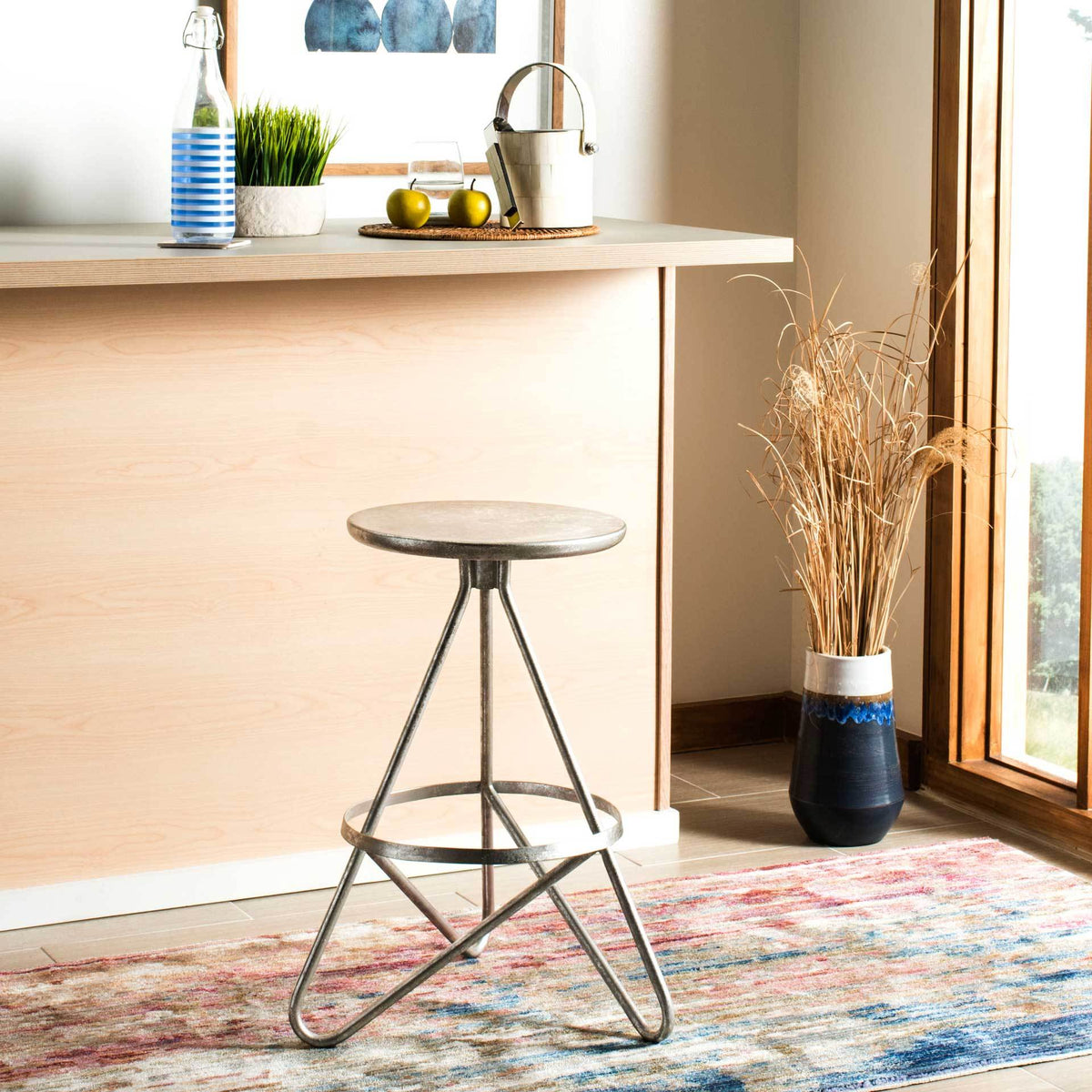 Sculptural silver leaf counter stool adds a gleaming accent beneath a kitchen island