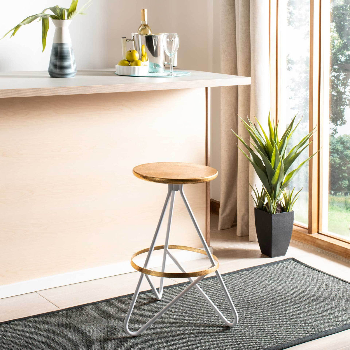 White and gold counter stool brings a gleaming accent to a sunny kitchen island