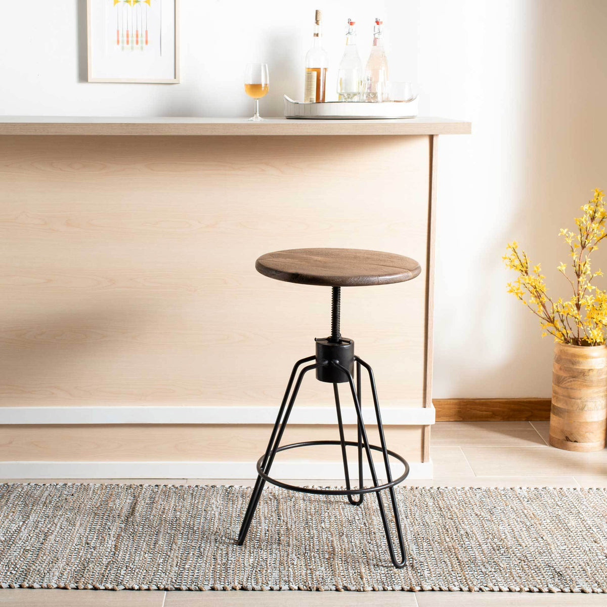 A raised honey-toned seat adds adaptable comfort to a sleek black iron counter stool.