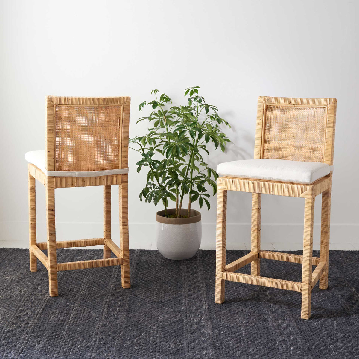 White-cushioned cane counter stools add warmth and texture to a casual room