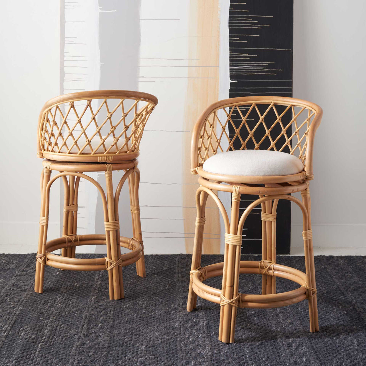 White-cushioned rattan stools add open diamond-weave texture to a modern seating area