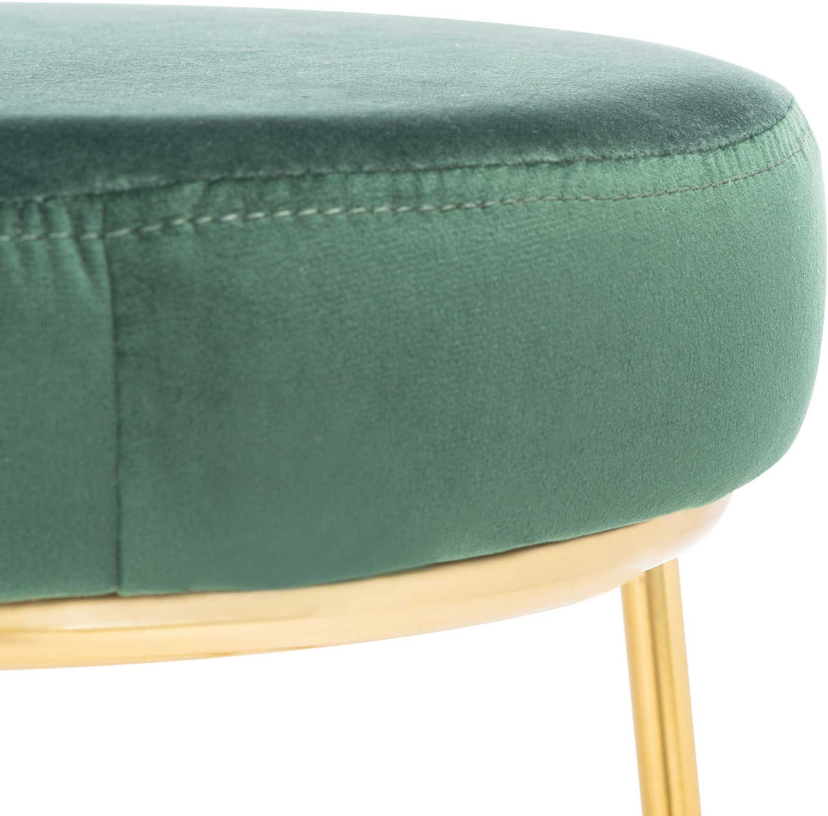 Rich green velvet wraps a thick seat with fine stitching and a gold edge