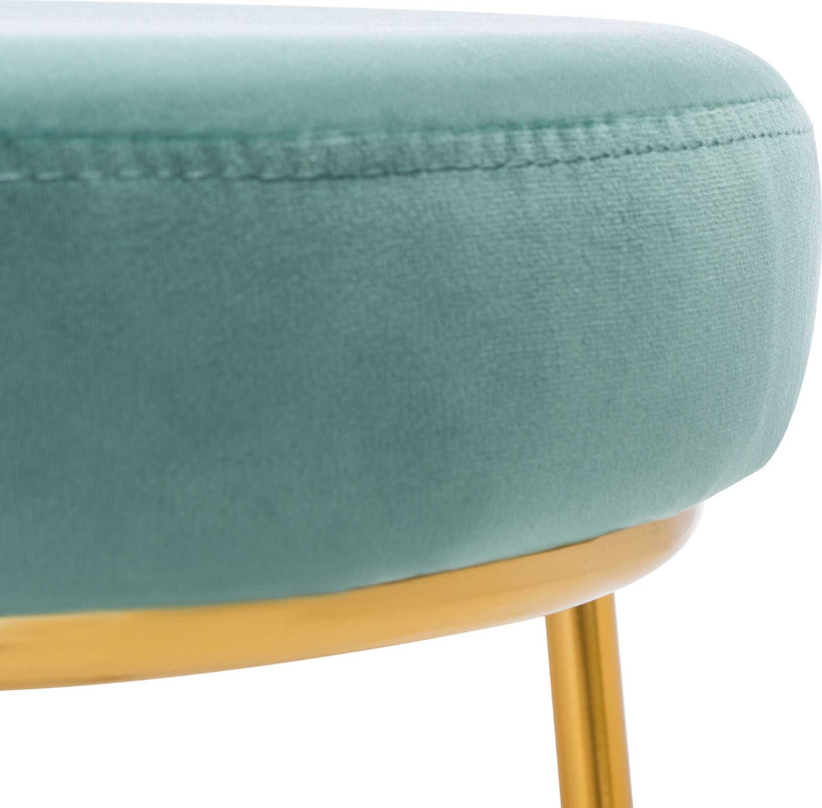 Soft seafoam velvet and neat stitching detail the thick, cushioned seat.