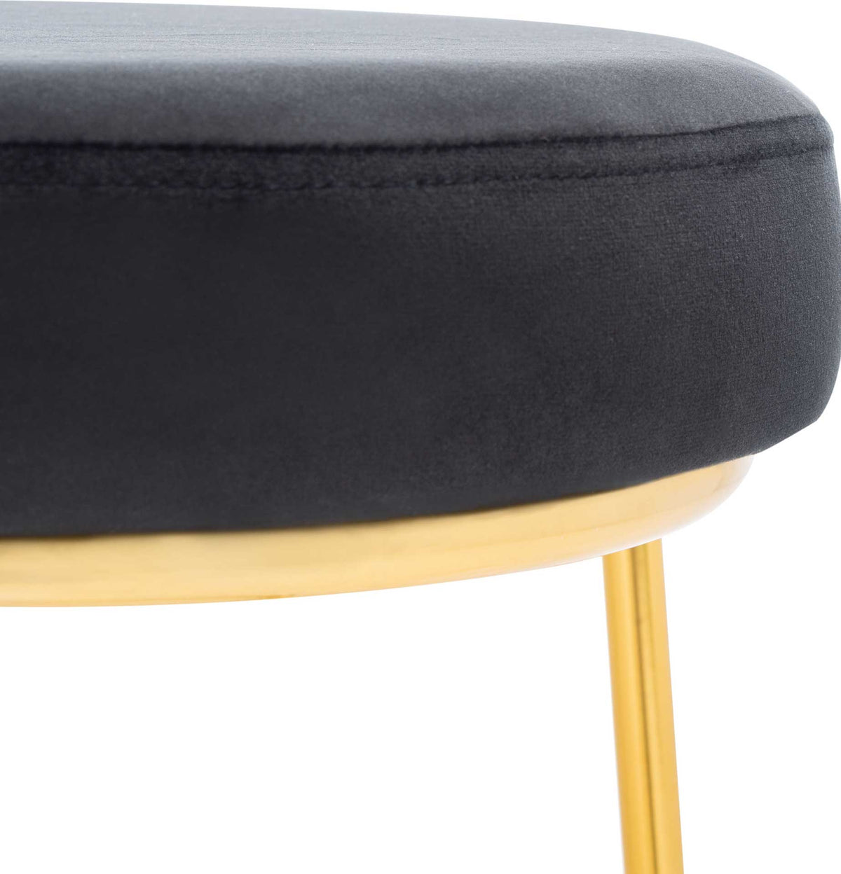 Smooth black velvet wraps a thick padded seat above a gleaming gold rim.
